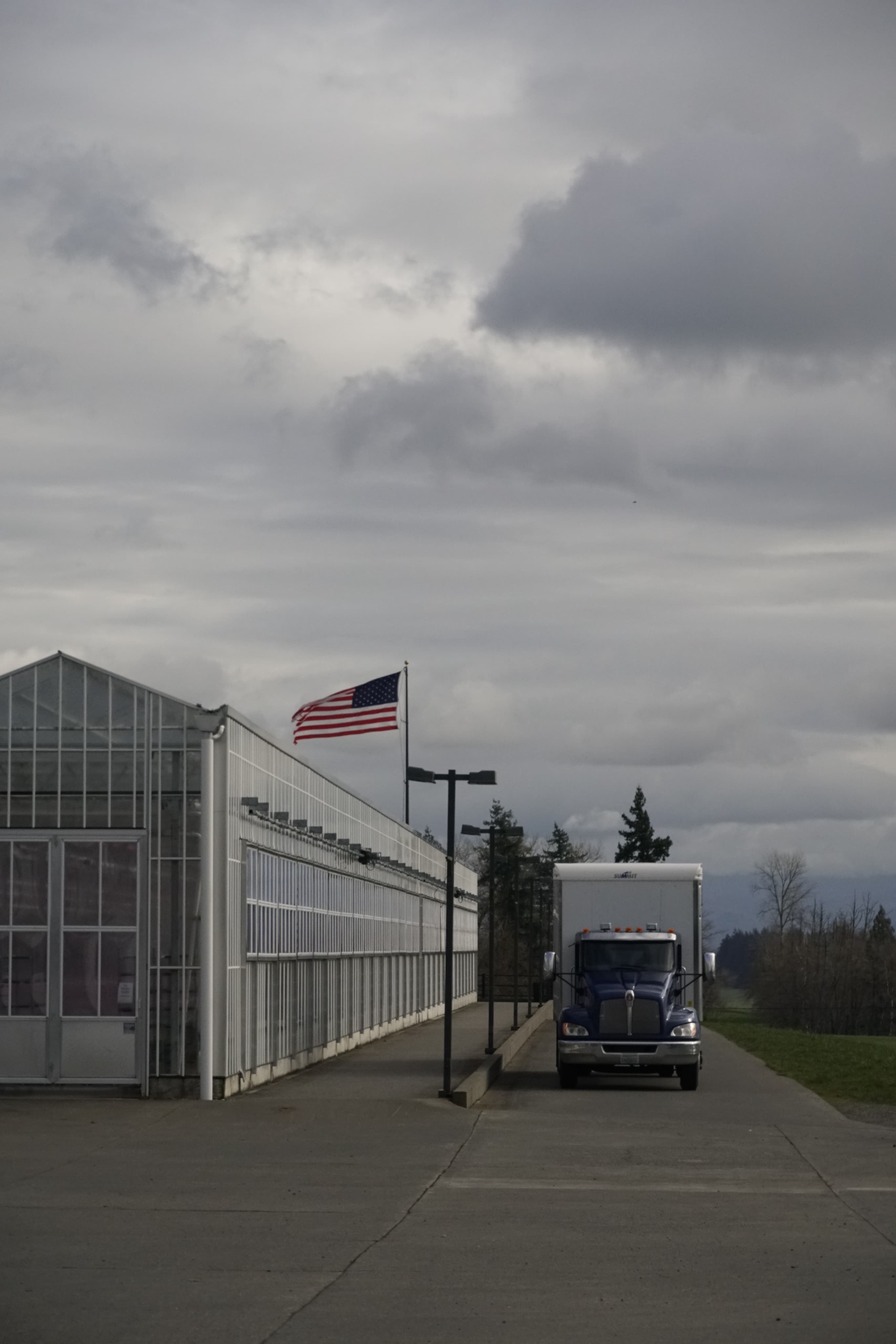 truck in front of greenhouses
